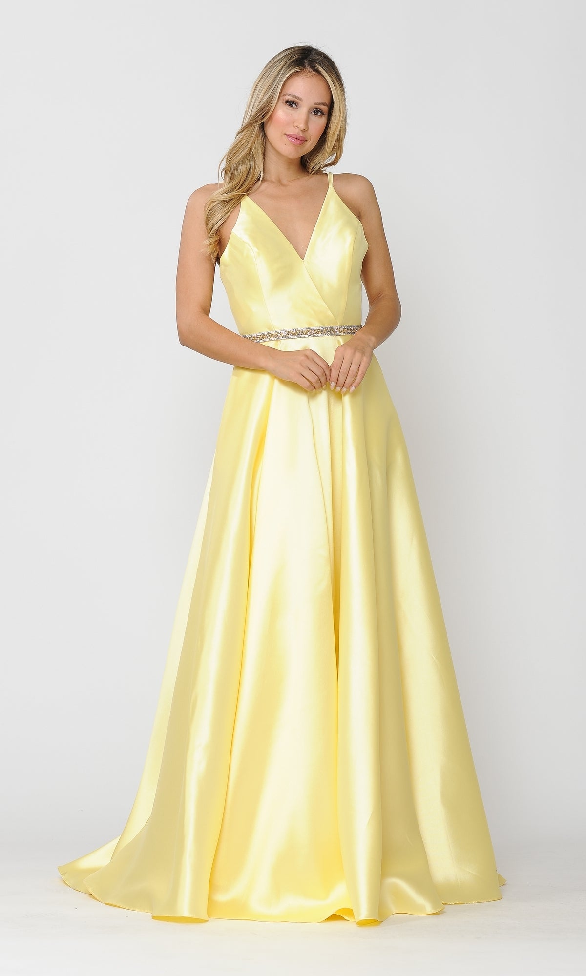 A woman stands against a plain white background wearing the Long A-Line Mikado Prom Gown 8690, a sleeveless yellow evening dress featuring a V-neckline, beaded waist, and pockets.